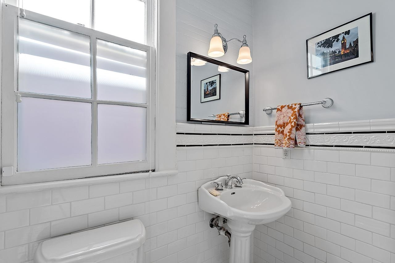 424 East Jones Street Raleigh, NC 27601 - Photo 16 of 27 a bathroom with a sink a toilet and mirror