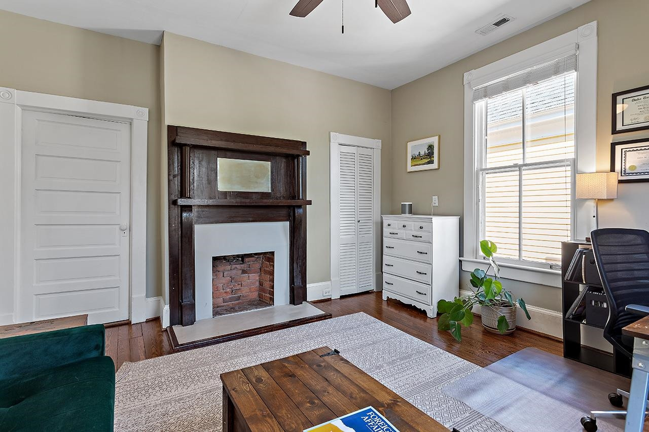 424 East Jones Street Raleigh, NC 27601 - Photo 22 of 27 a living room with furniture and a fireplace