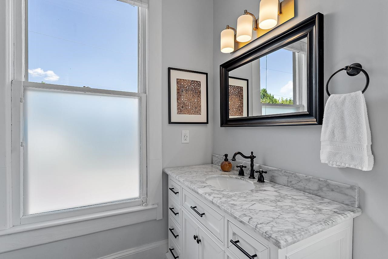 424 East Jones Street Raleigh, NC 27601 - Photo 23 of 27 a bathroom with a granite countertop sink and a window