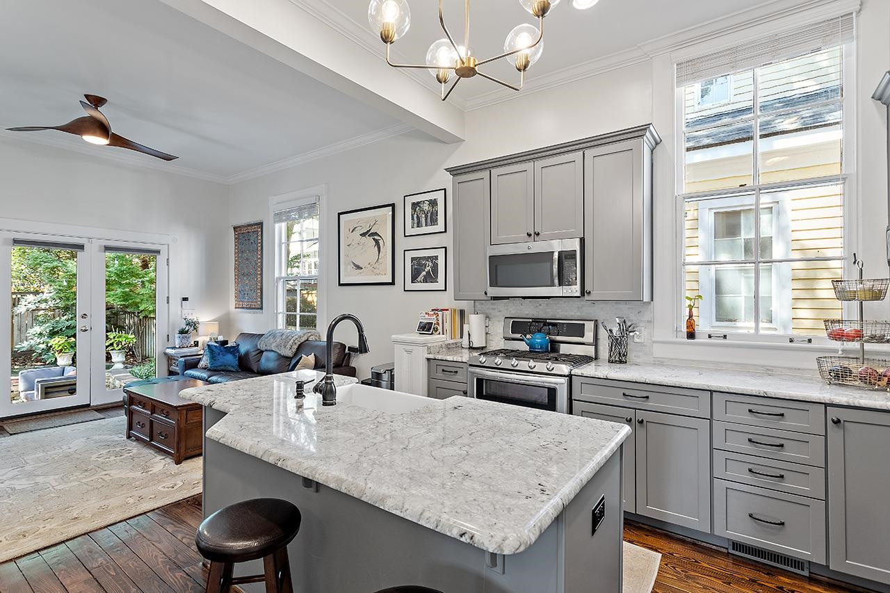 424 East Jones Street Raleigh, NC 27601 - Photo 5 of 27 a kitchen with granite countertop a sink appliances cabinets and furniture