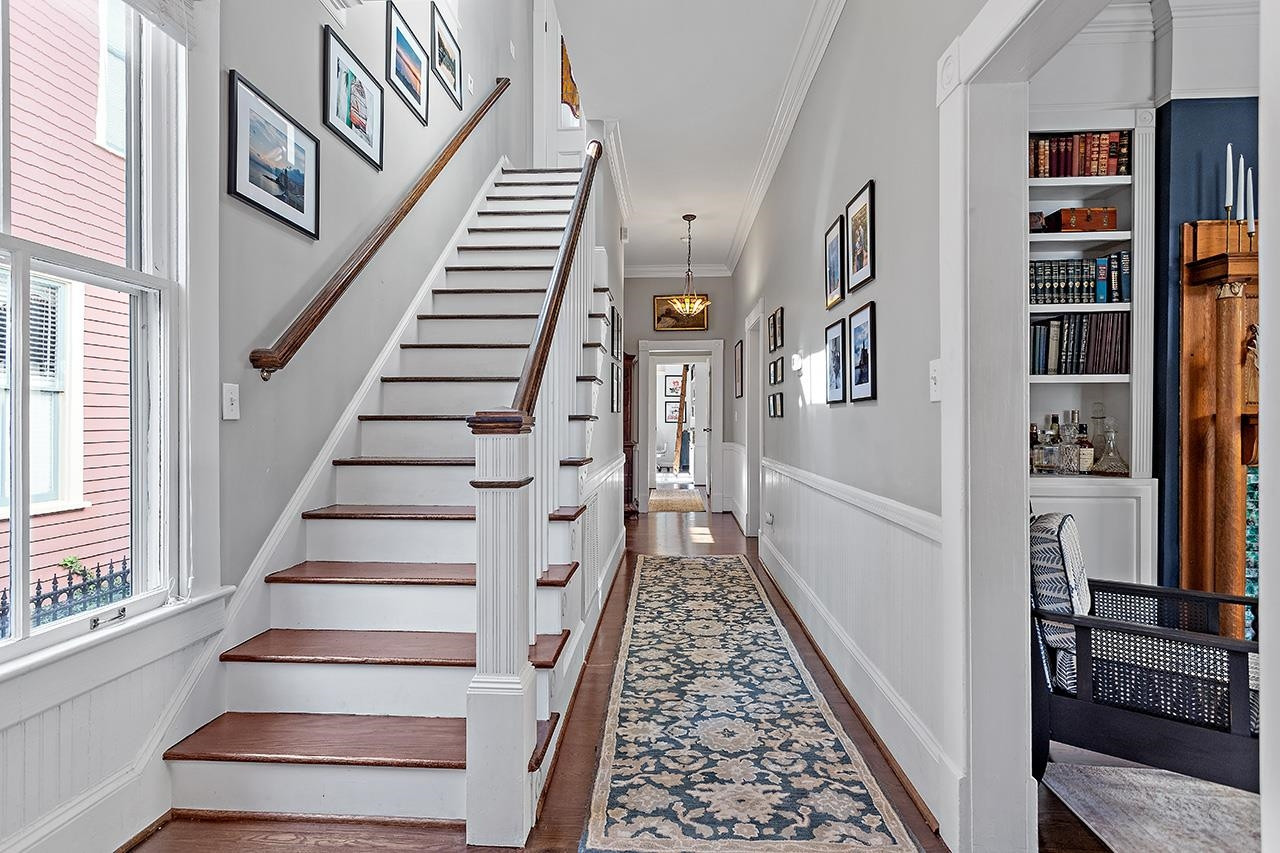 424 East Jones Street Raleigh, NC 27601 - Photo 9 of 27 a view of staircase with lots of frames on wall and a window