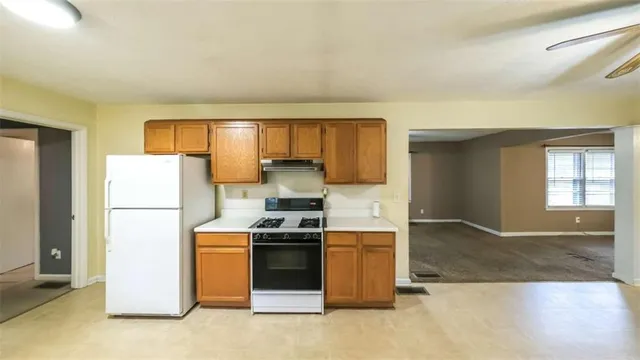 a kitchen with a stove a refrigerator and a sink