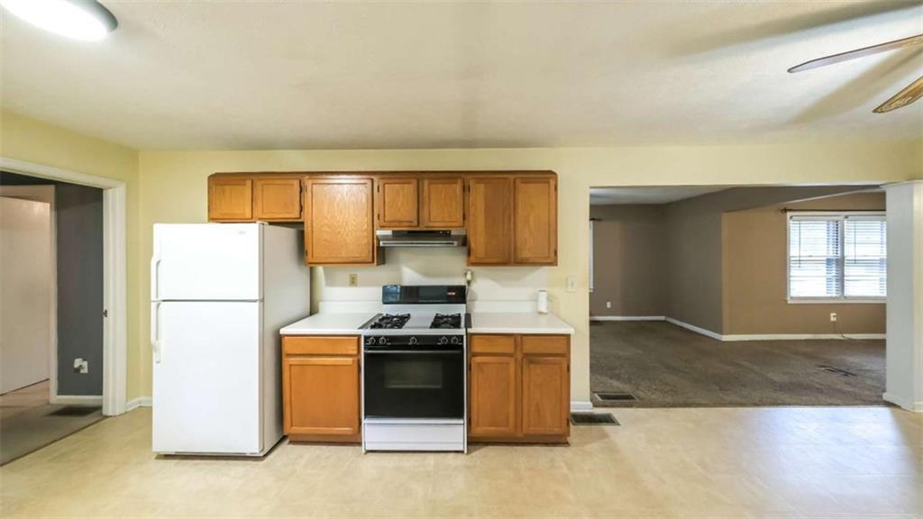 7146 Old Beulah Road Lithia Springs, GA 30122 - Photo 13 of 45 a kitchen with a stove a refrigerator and a sink