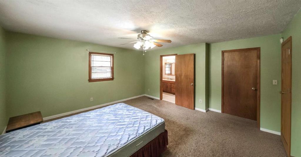7146 Old Beulah Road Lithia Springs, GA 30122 - Photo 17 of 45 an empty room with chandelier fan and windows