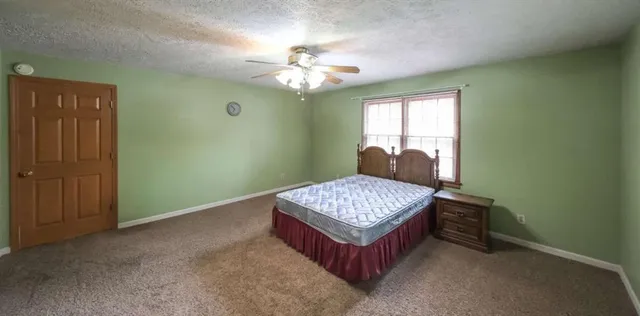 a room with a bed and a chandelier