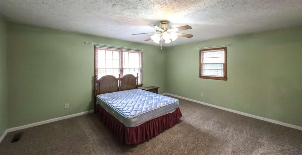 7146 Old Beulah Road Lithia Springs, GA 30122 - Photo 20 of 45 a living room with a couch and chandelier