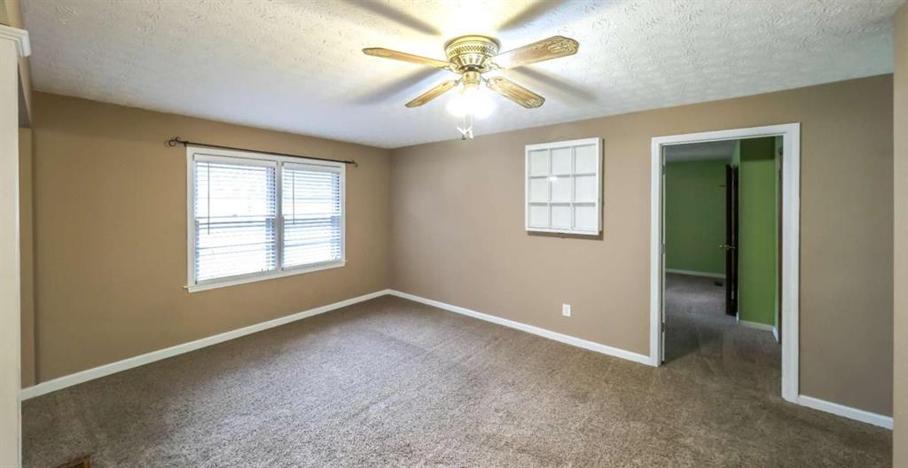 7146 Old Beulah Road Lithia Springs, GA 30122 - Photo 21 of 45 an empty room with windows and chandelier fan