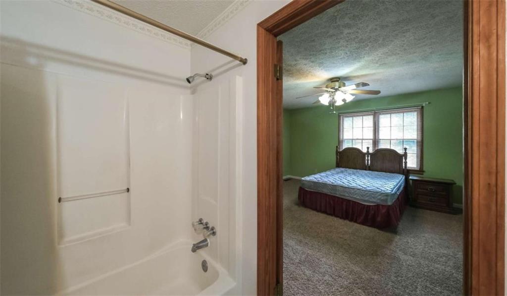 7146 Old Beulah Road Lithia Springs, GA 30122 - Photo 22 of 45 a living room with furniture and a mirror