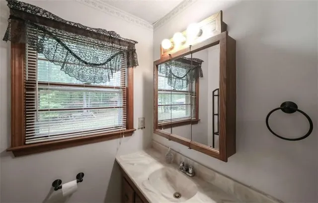 a bathroom with a sink vanity and mirror