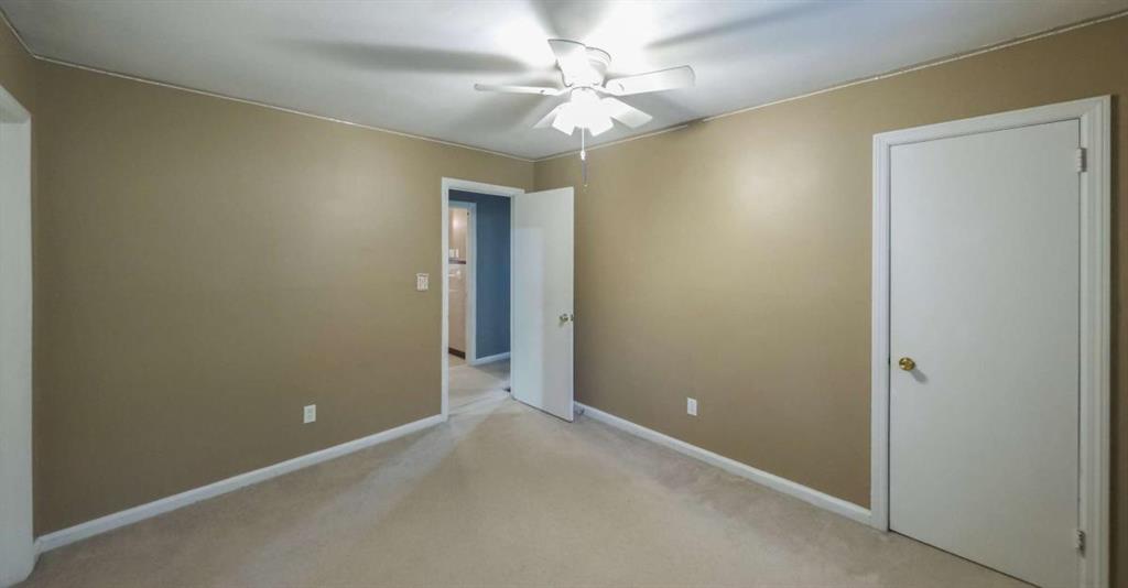 7146 Old Beulah Road Lithia Springs, GA 30122 - Photo 27 of 45 an empty room with a chandelier fan and a chandelier fan