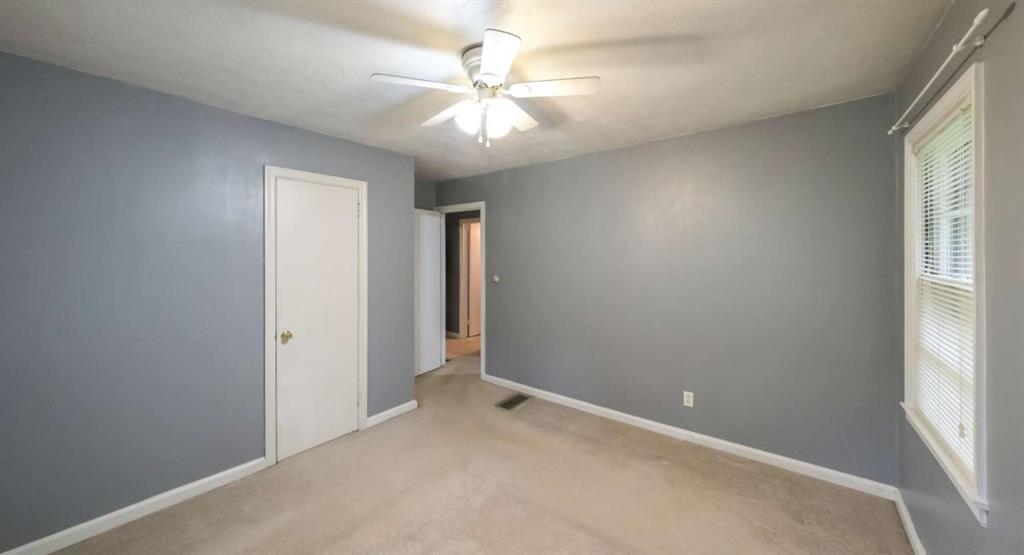 7146 Old Beulah Road Lithia Springs, GA 30122 - Photo 28 of 45 an empty room with windows and fan
