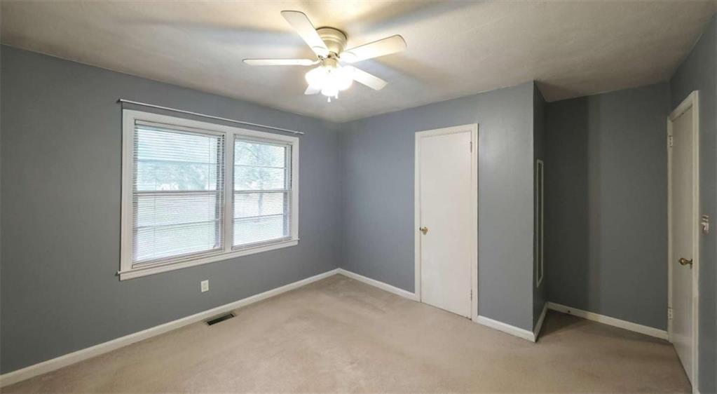 7146 Old Beulah Road Lithia Springs, GA 30122 - Photo 29 of 45 an empty room with windows and fan