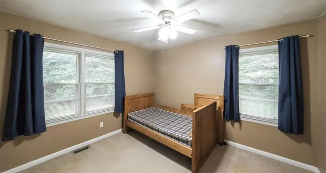 a room with window and ceiling fan