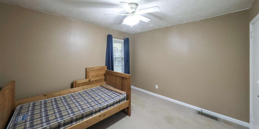 7146 Old Beulah Road Lithia Springs, GA 30122 - Photo 33 of 45 a bedroom with a bed and a chandelier