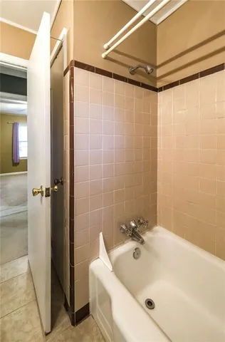 a bathroom with a white bath tub and a shower
