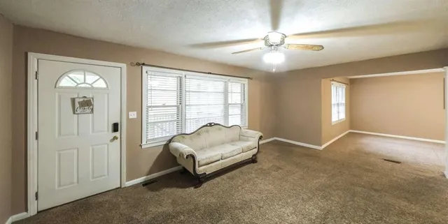 a living room with furniture and a chandelier