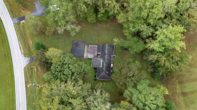a aerial view of a house with a yard