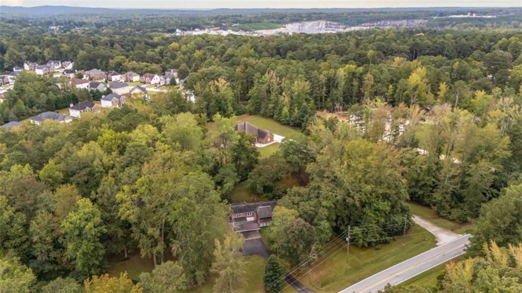 7146 Old Beulah Road Lithia Springs, GA 30122 - Photo 44 of 45 an aerial view of residential houses with outdoor space and trees