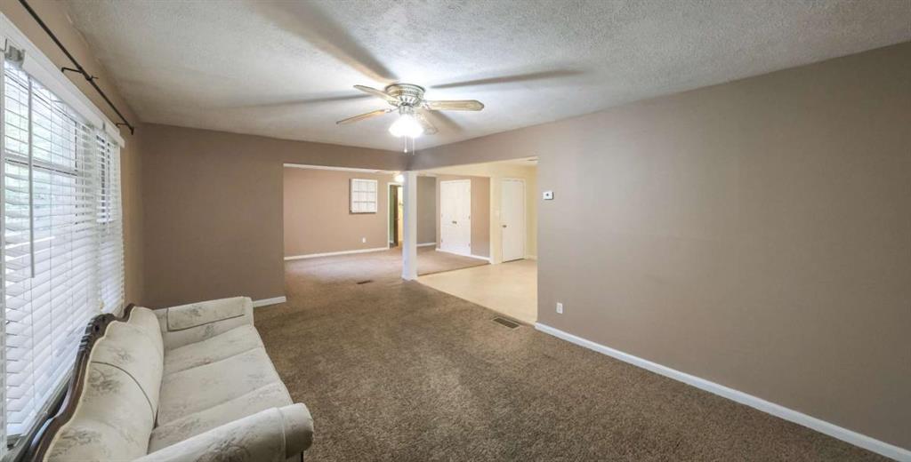 7146 Old Beulah Road Lithia Springs, GA 30122 - Photo 5 of 45 a living room with furniture and a chandelier
