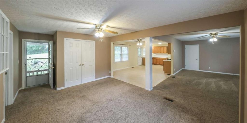 7146 Old Beulah Road Lithia Springs, GA 30122 - Photo 8 of 45 a view of a big room with windows and chandelier fan