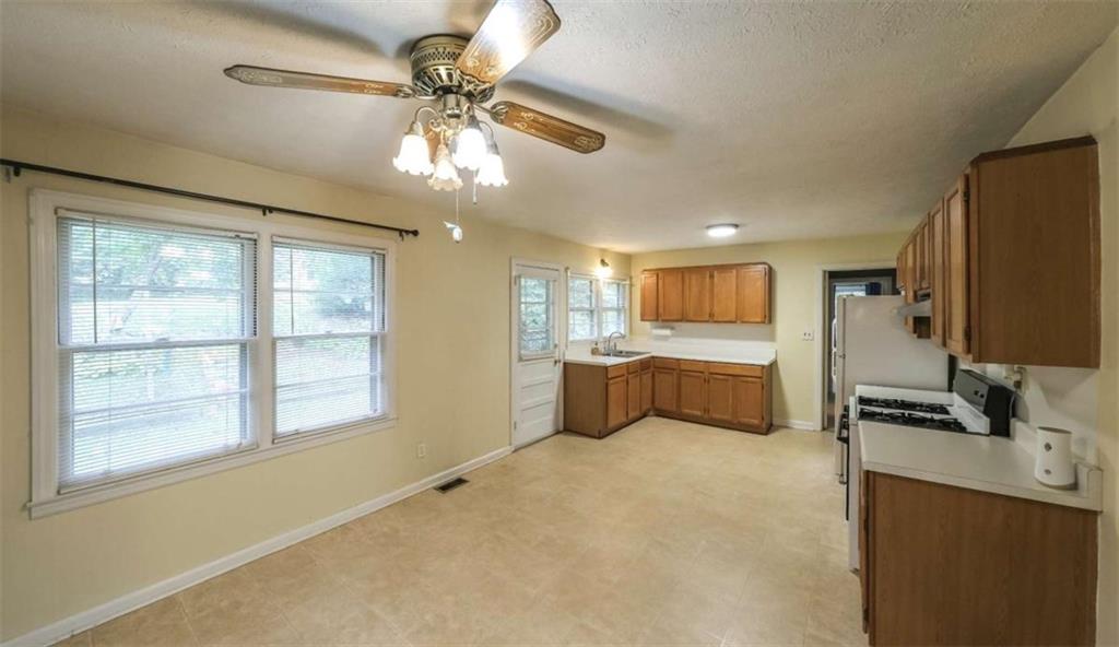 7146 Old Beulah Road Lithia Springs, GA 30122 - Photo 10 of 45 a kitchen with stainless steel appliances a large counter top space appliances and a window