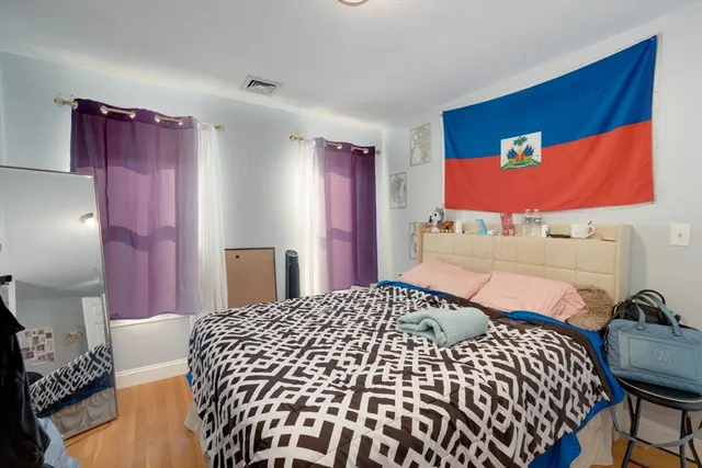 a bedroom with a bed and dresser