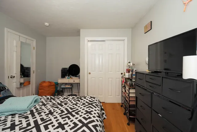 a bedroom with a bed and a flat screen tv