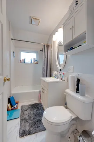 a bathroom with a toilet a sink and bathtub
