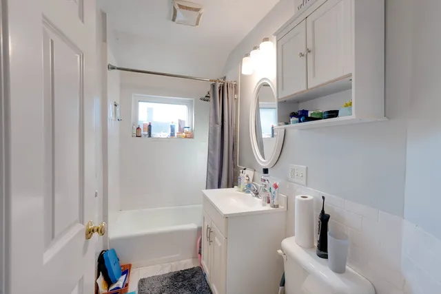 a bathroom with a sink a toilet and bathtub