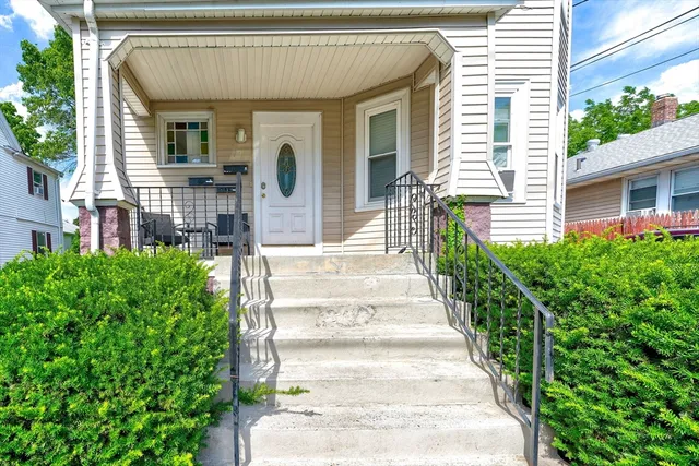 a front view of a house with a garden