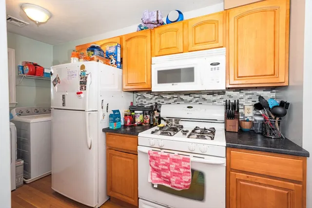 a kitchen with stainless steel appliances a stove a refrigerator and a sink