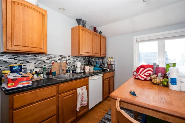 a kitchen with stainless steel appliances a sink a stove and a window