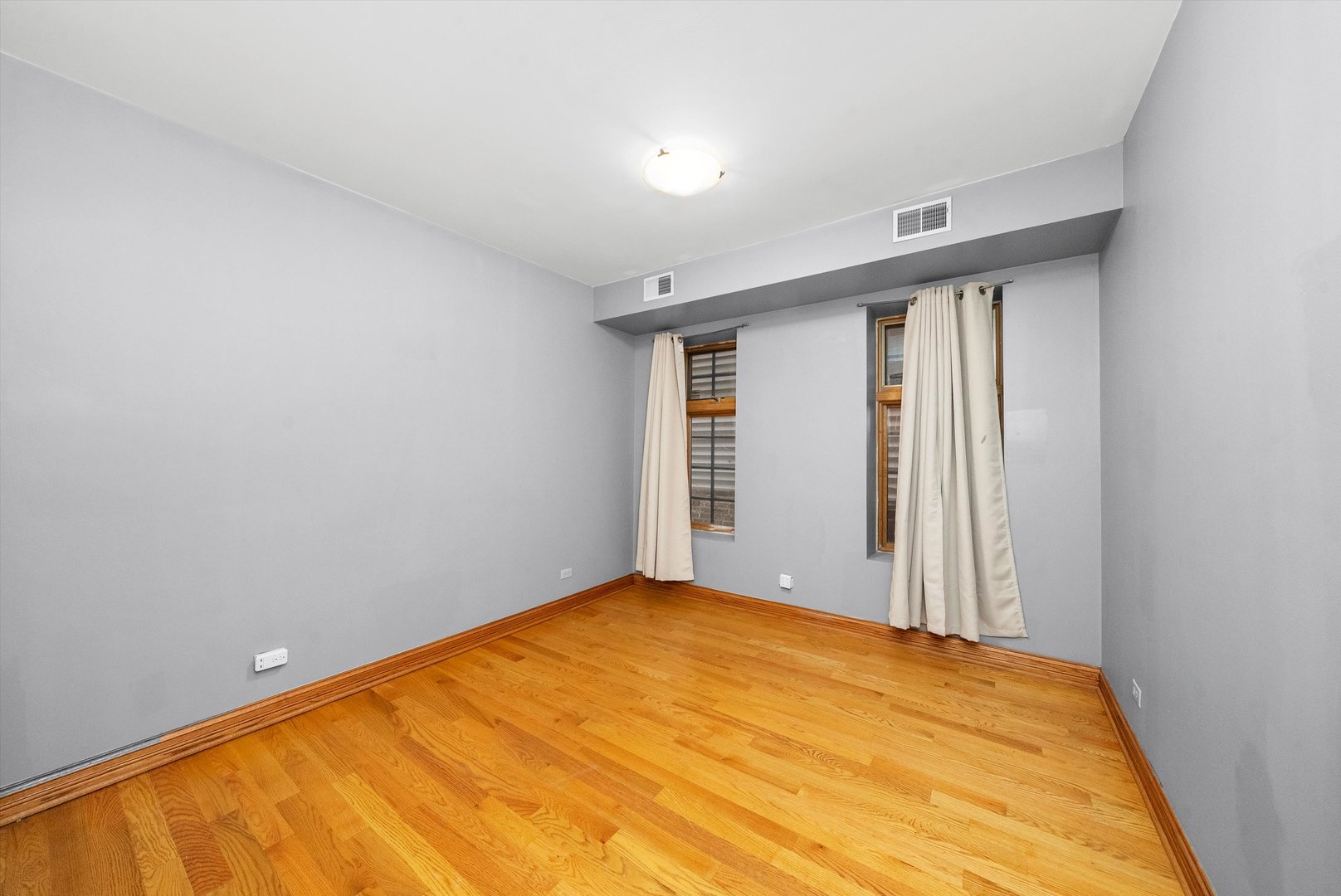 1936 South Racine Avenue Chicago, IL 60608 - Photo 26 of 48 a view of empty room with wooden floor and fan