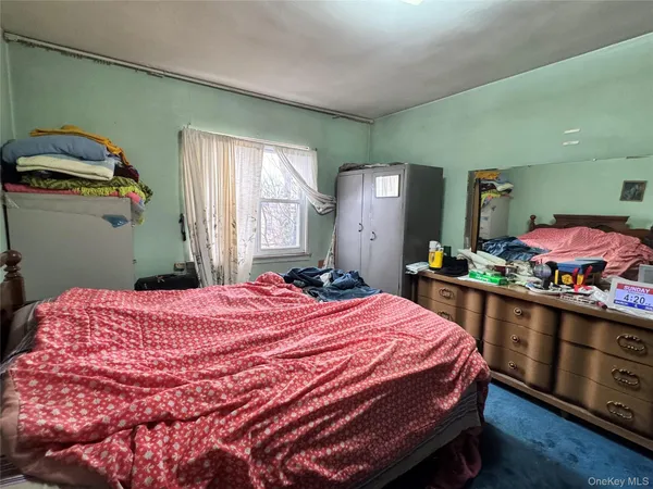 a bedroom with a bed and window