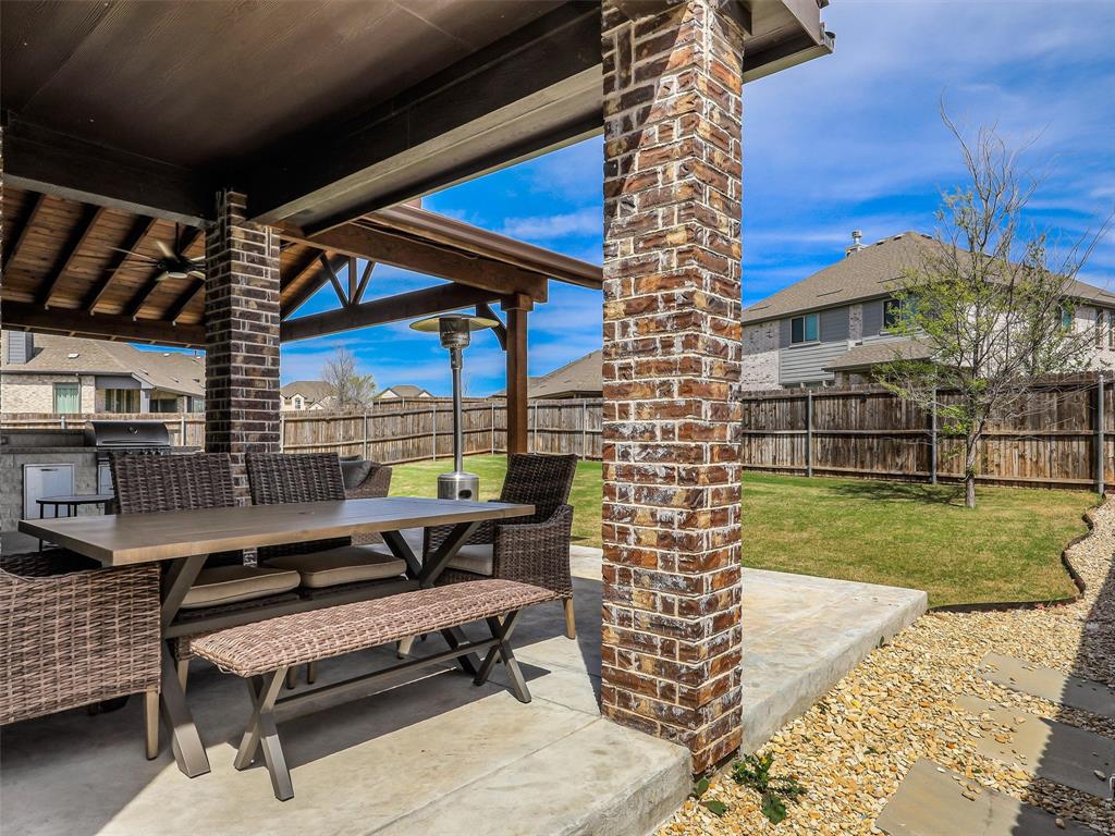 1216 Tree Shadow Lane Anna, TX 75409 - Photo 34 of 37 a roof deck with table and chairs and potted plants