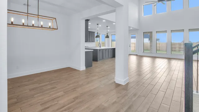 a view of a kitchen with wooden floor and a window