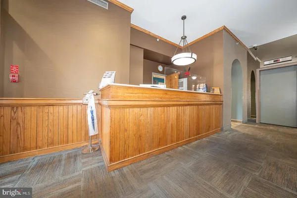 a dining room with wooden floor and white walls