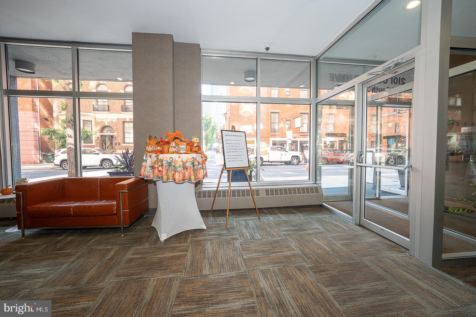 118 South 21st Street, Unit 218 Philadelphia, PA 19103 - Photo 12 of 20 a living room with furniture and large windows