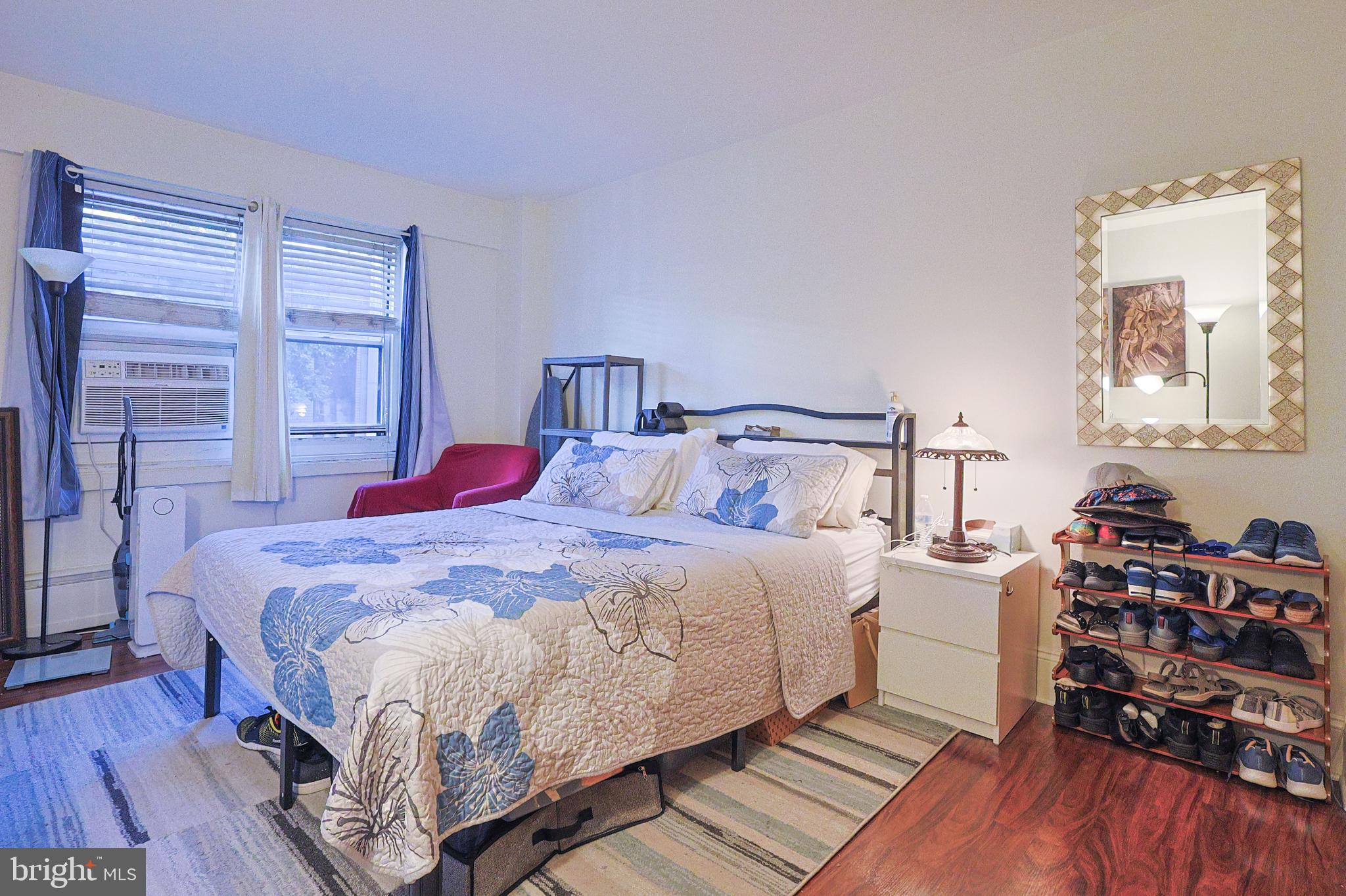 118 South 21st Street, Unit 218 Philadelphia, PA 19103 - Photo 7 of 20 a bedroom with a bed and wooden floor