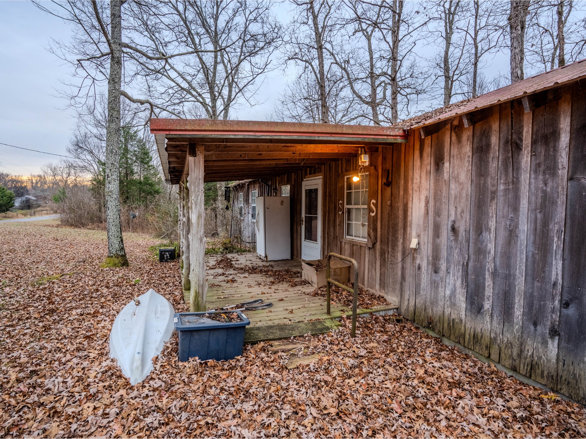 a backyard of a house with barbeque oven table and chairs
