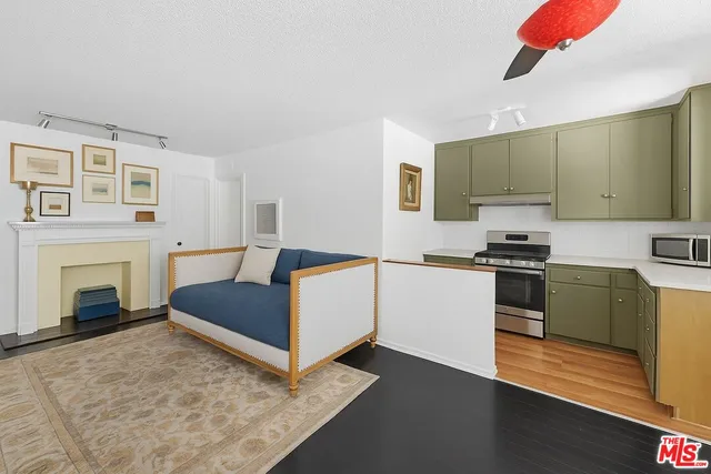 a kitchen with a refrigerator and a stove top oven