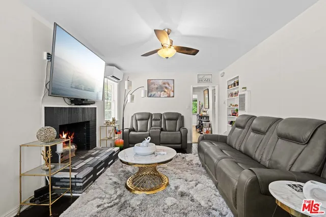 a living room with furniture a fireplace and a table