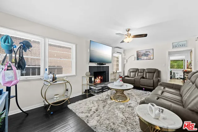 a living room with furniture a fireplace and a chandelier