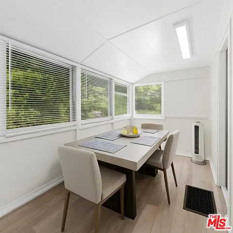 a view of a dining room with furniture and window