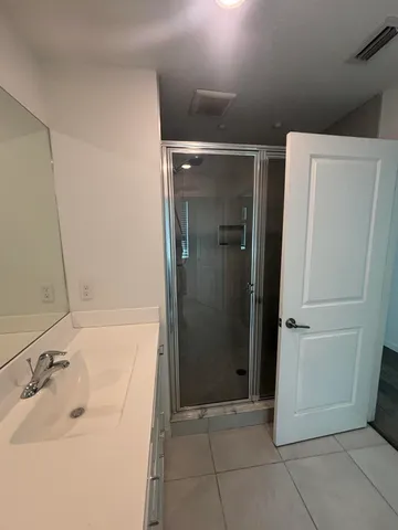 a bathroom with a sink and a shower