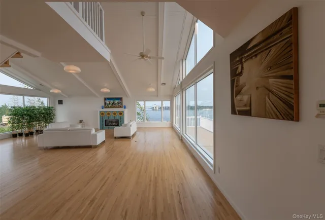 a view of a hallway with wooden floor and furniture
