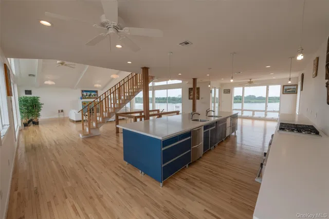 a kitchen with stainless steel appliances granite countertop a refrigerator a stove and a wooden floors