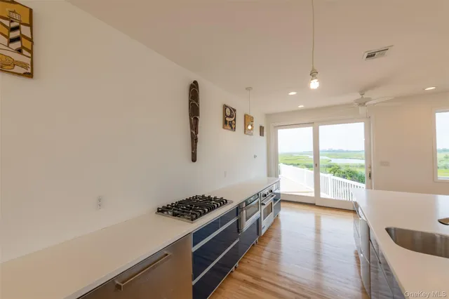 a hallway with a large window and wooden floor