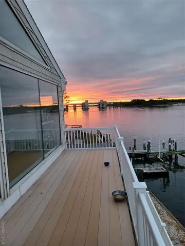 a view of a balcony with wooden floor and lake