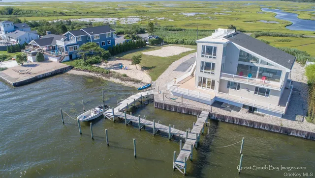 an aerial view of a house with a ocean view